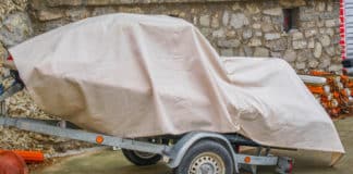 Securing Your Jet Ski Off-Season: Essential Preparation and Winterization Tips jet ski on trailer with a cover over it