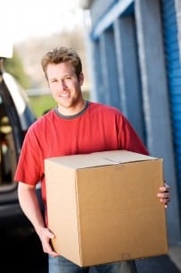 man moving boxes into a storage unit