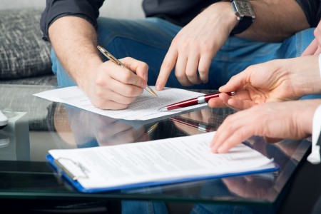 man signing sublease agreement